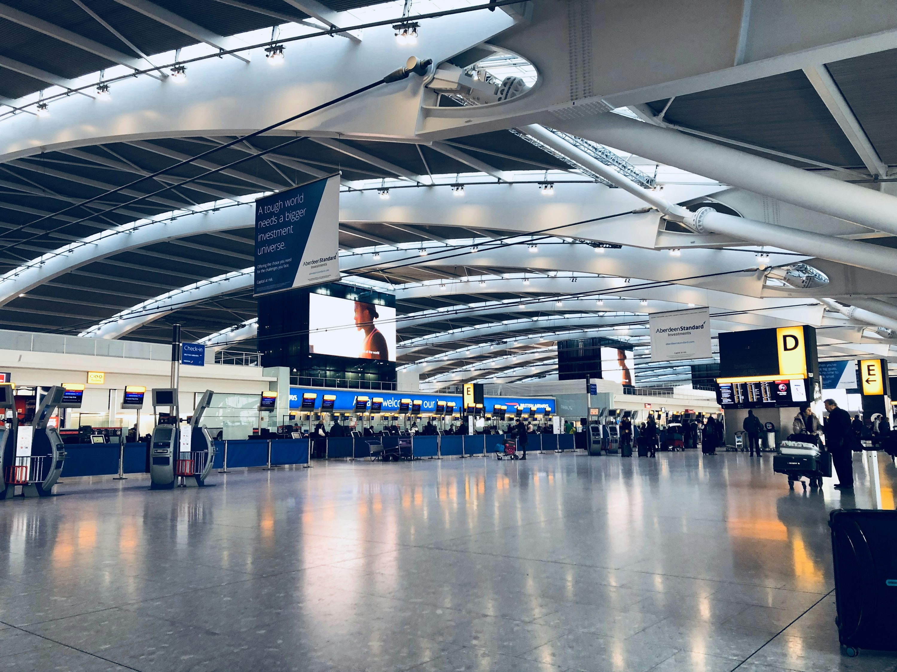 Modern airport terminal with clear signage and organized passenger flow